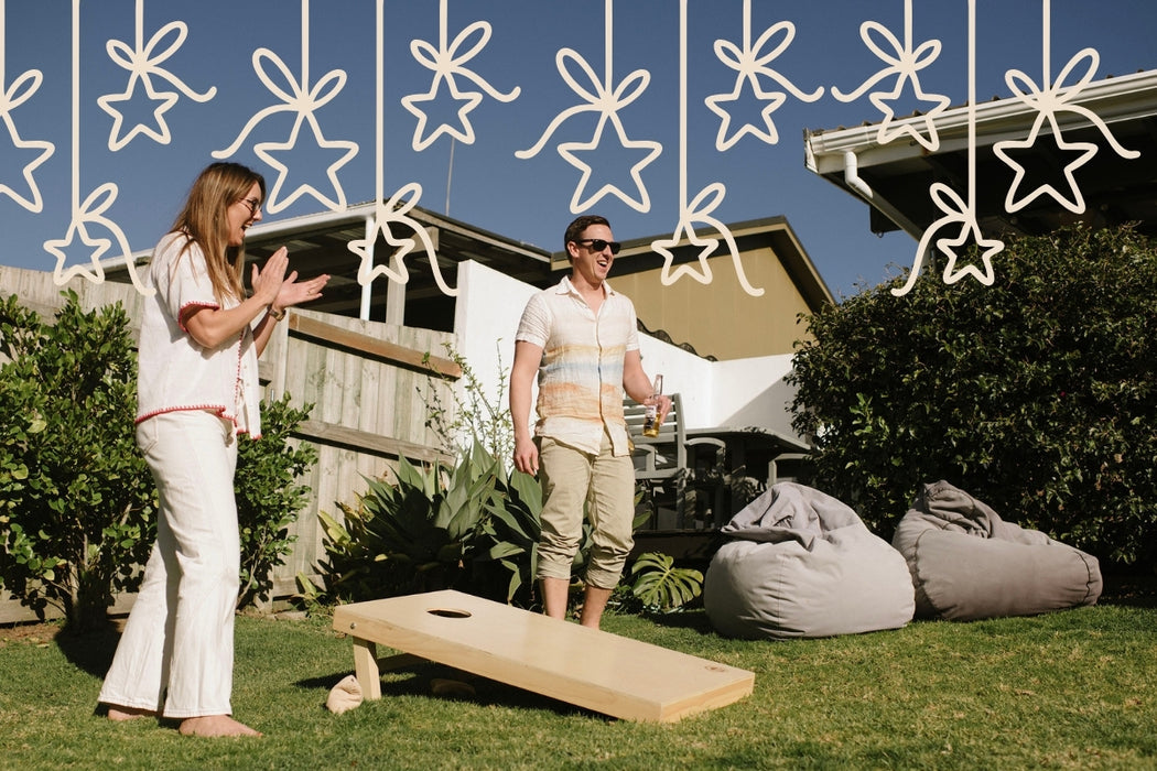 Two people playing Cornhole