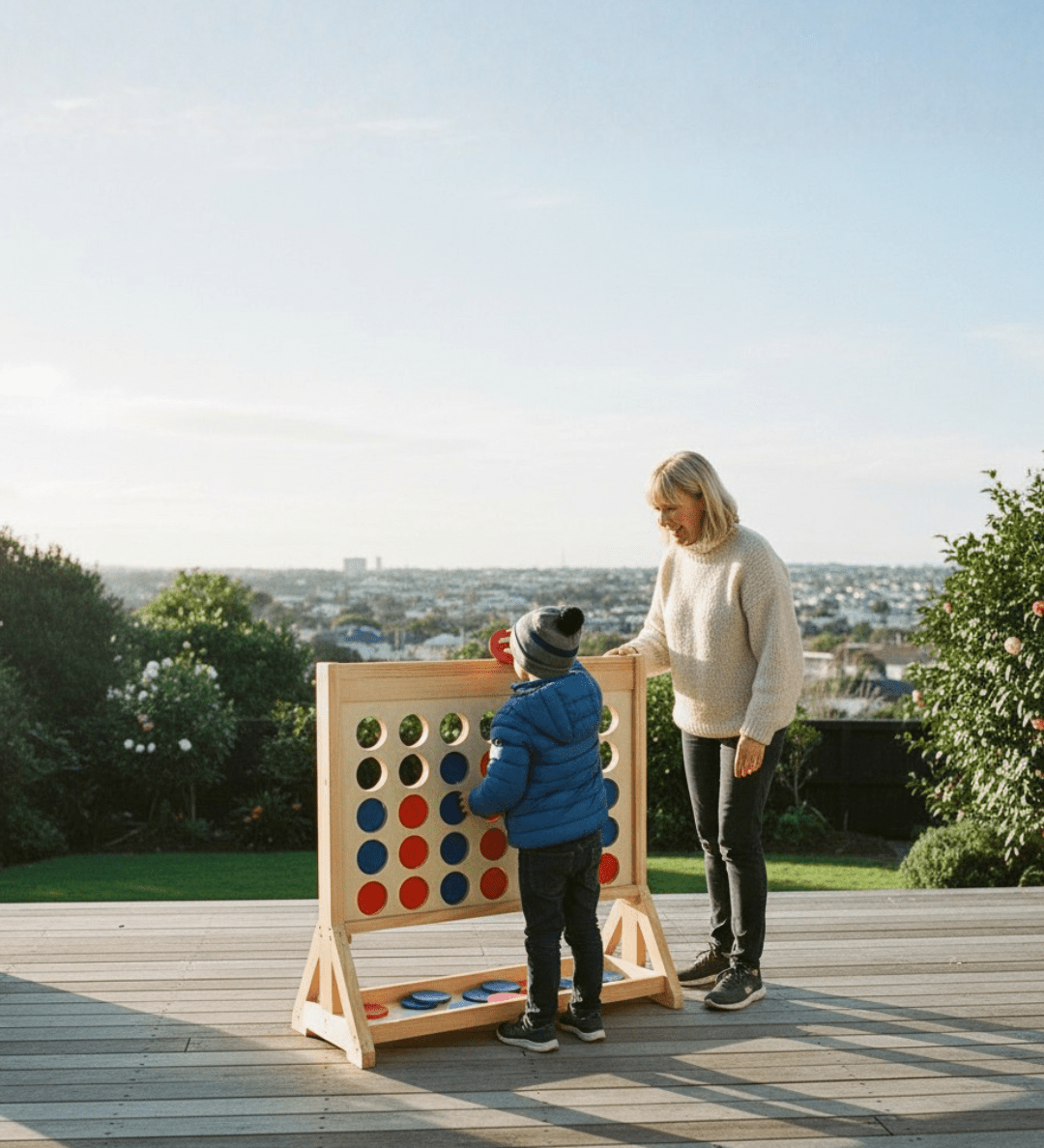 Woman and child playing Giant Connect Four on deck in winter