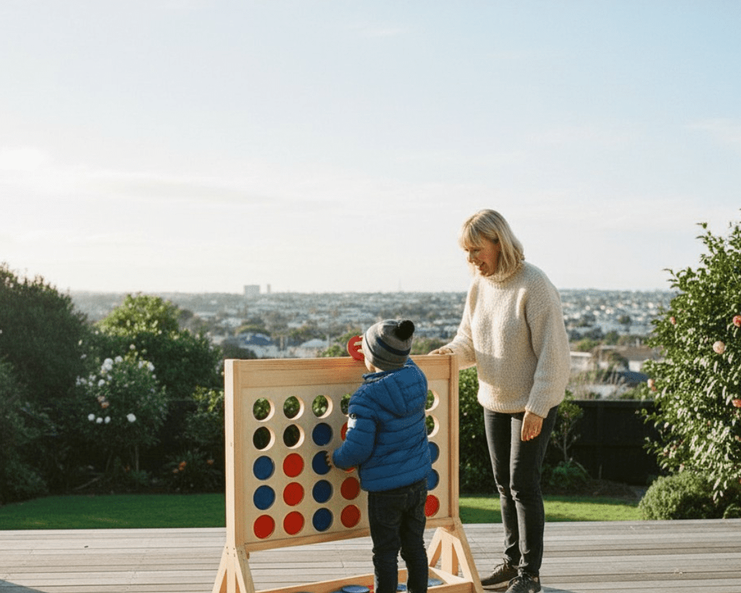 Woman and child playing Giant Connect Four on deck in winter