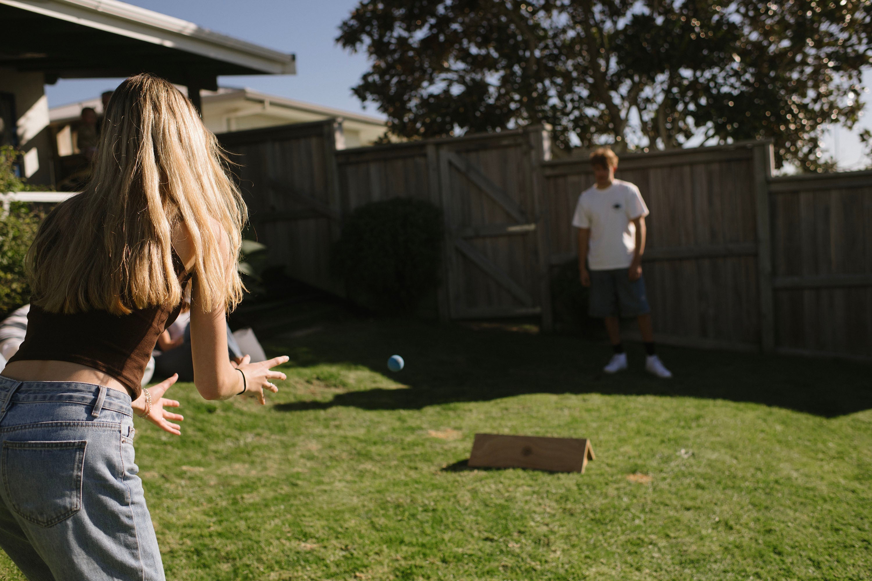 Kids playing outdoor games in a New Zealand backyard during school holidays