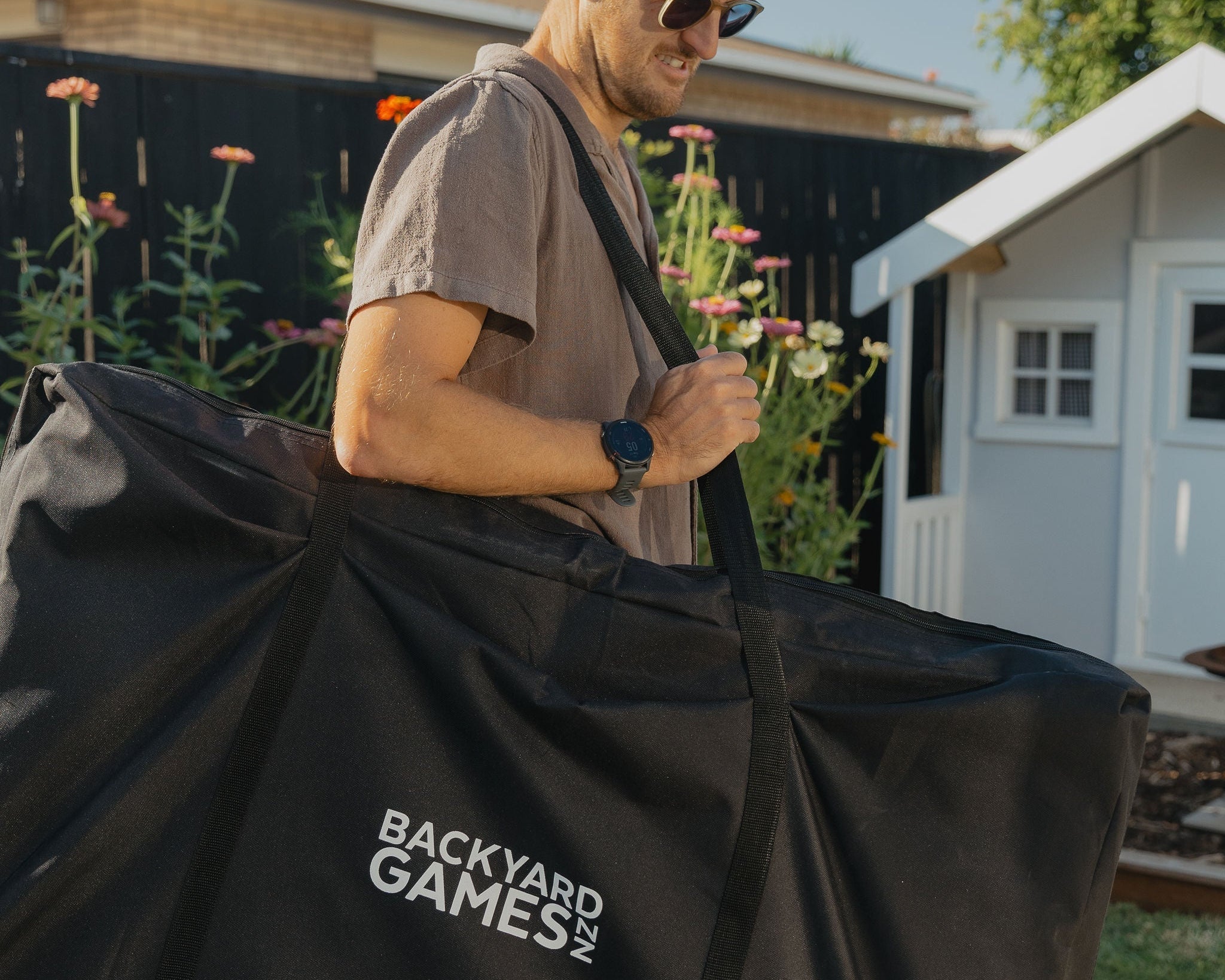 Dad carrying Cornhole in cornhole carry case