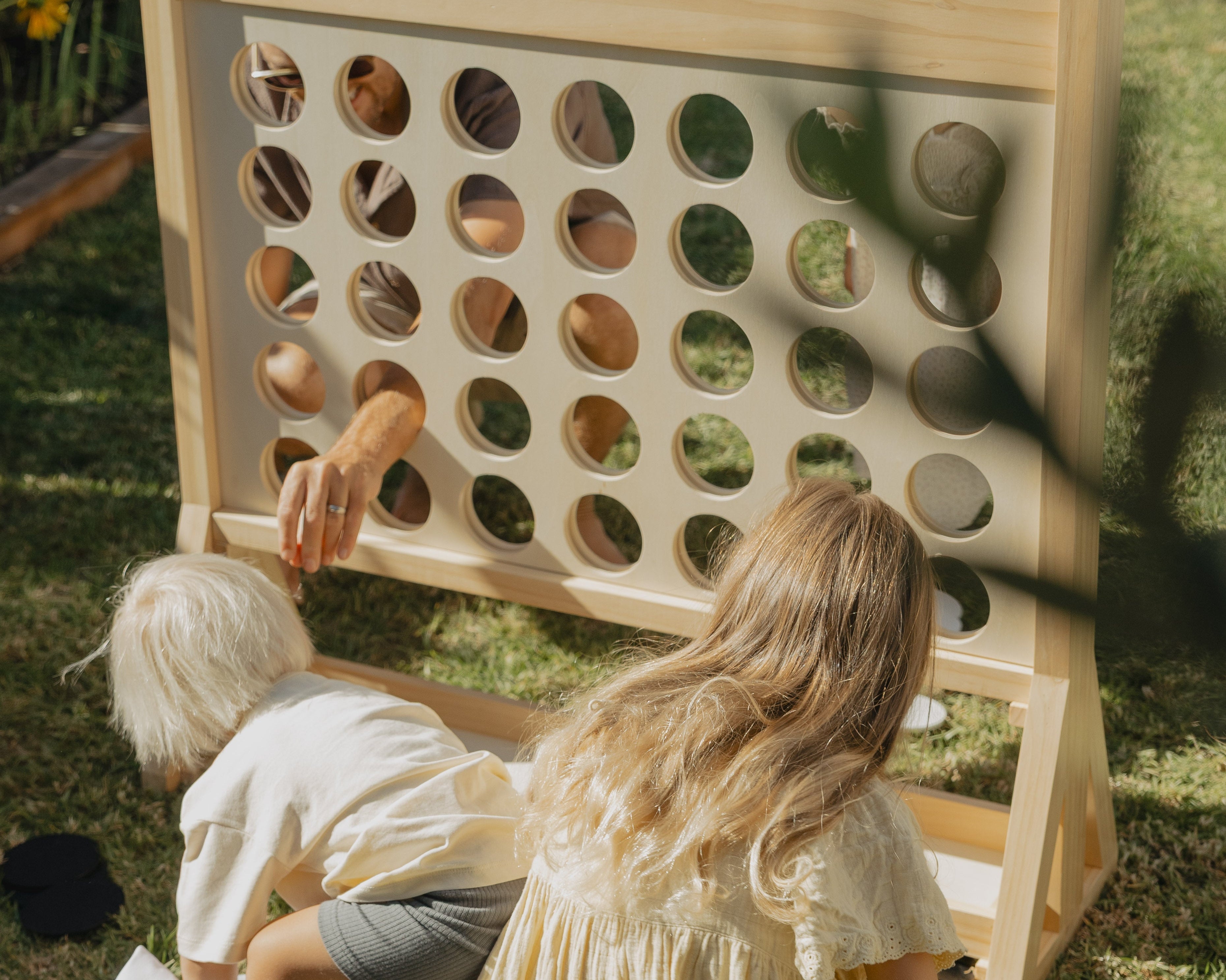 family playing giant connect four