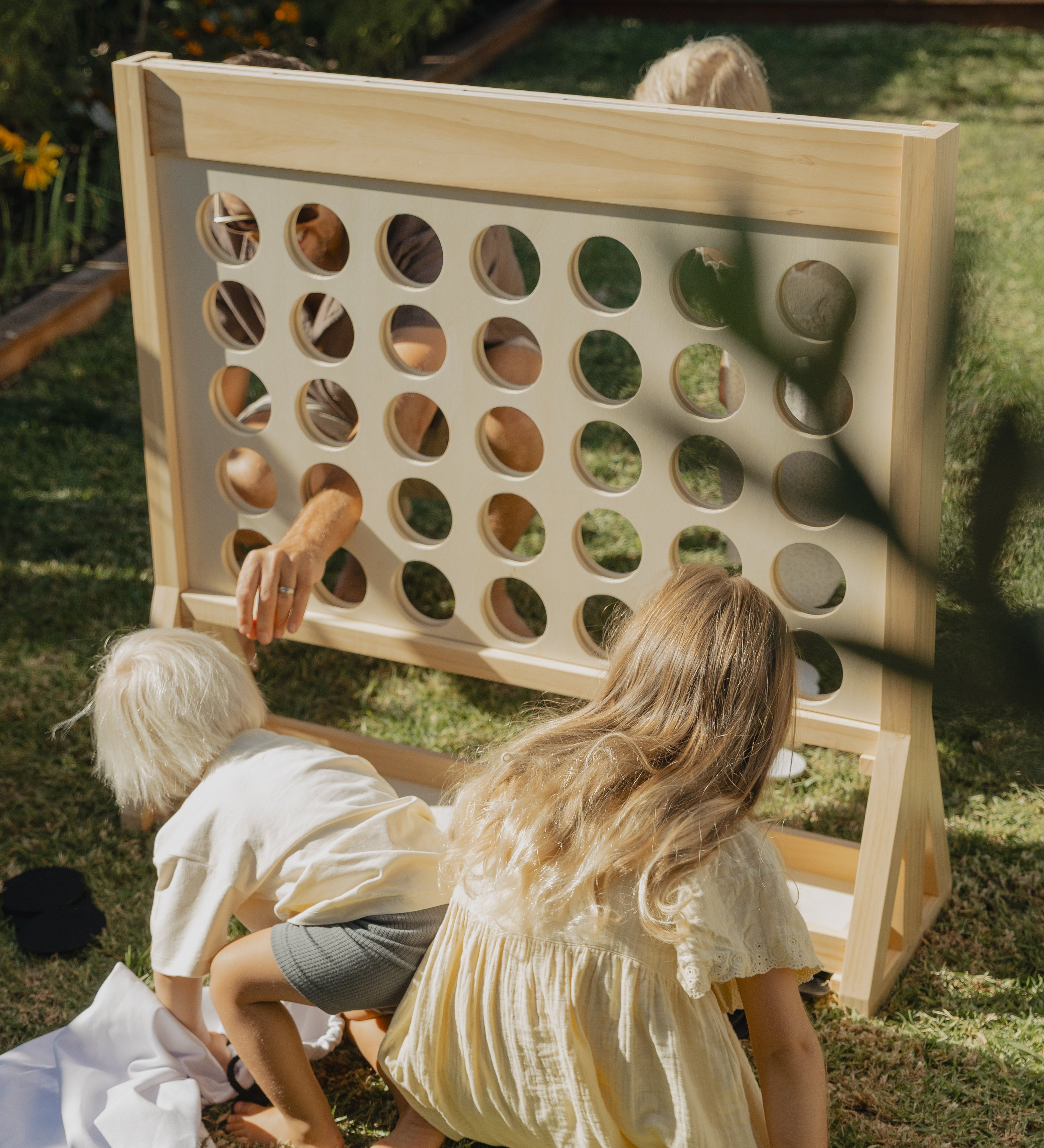 family playing giant connect four