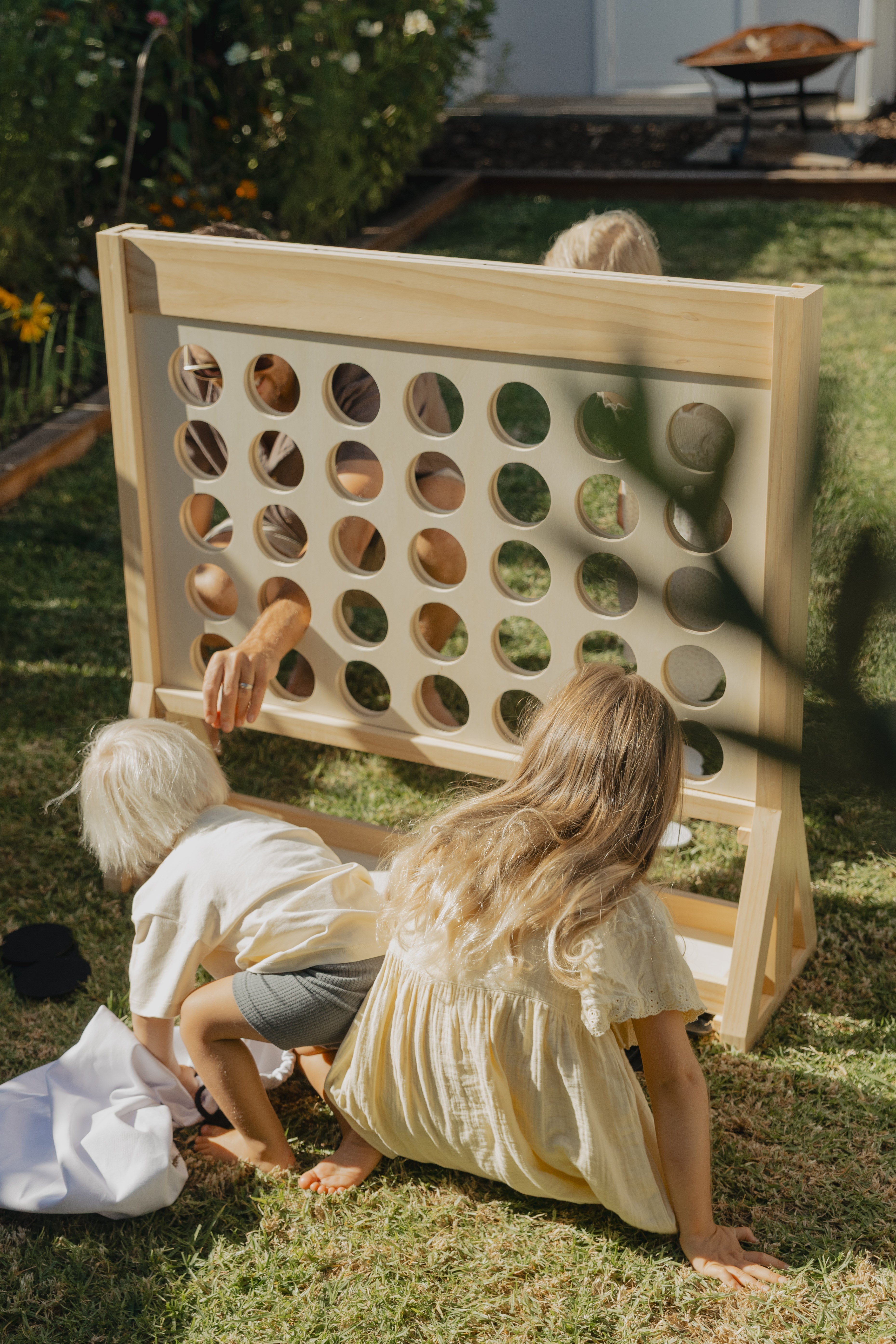 family playing giant connect four