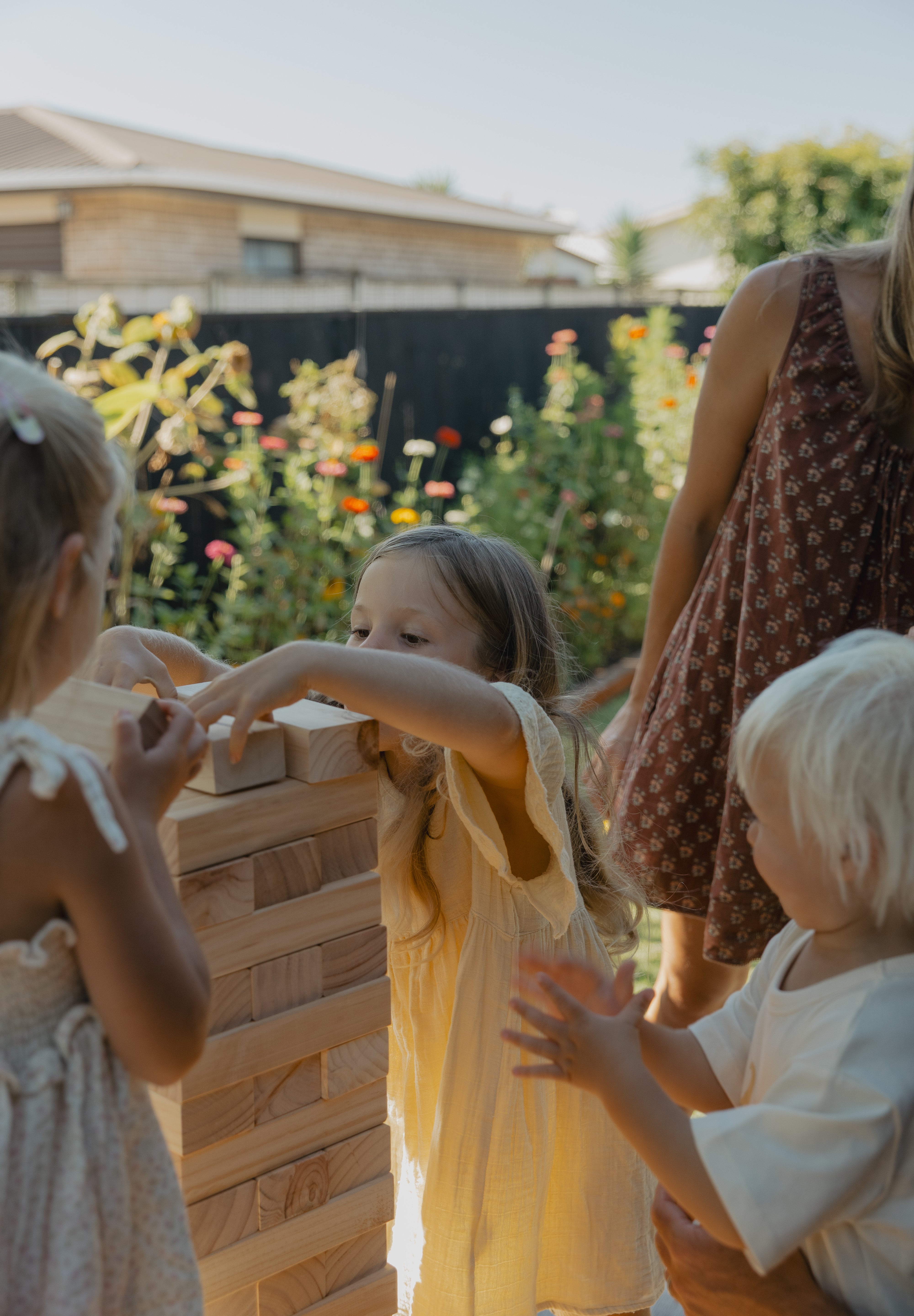Children Playing with Backyard Games Tumbling Tower outside 