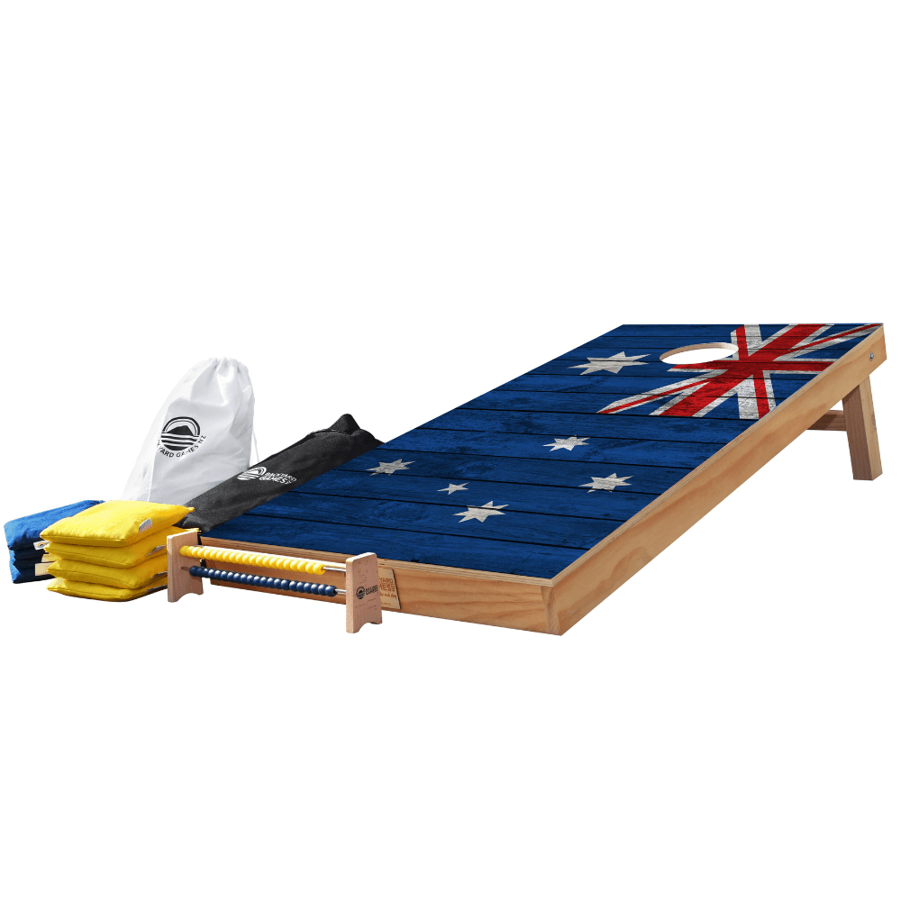 Wooden cornhole boards with an Australian flag design, shown with folded yellow bean bags, a white drawstring bag, and a black bag on a plain white background.