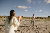 Frescobol Beach Tennis Set NZ — premium hardwood dual-tone bats being played on the beach