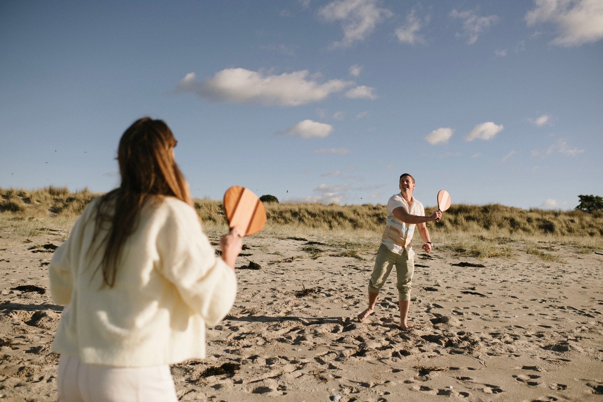 Frescobol Beach Tennis Set NZ — premium hardwood dual-tone bats being played on the beach