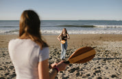 Frescobol Beach Tennis Set NZ — premium hardwood dual-tone bats being played on the beach