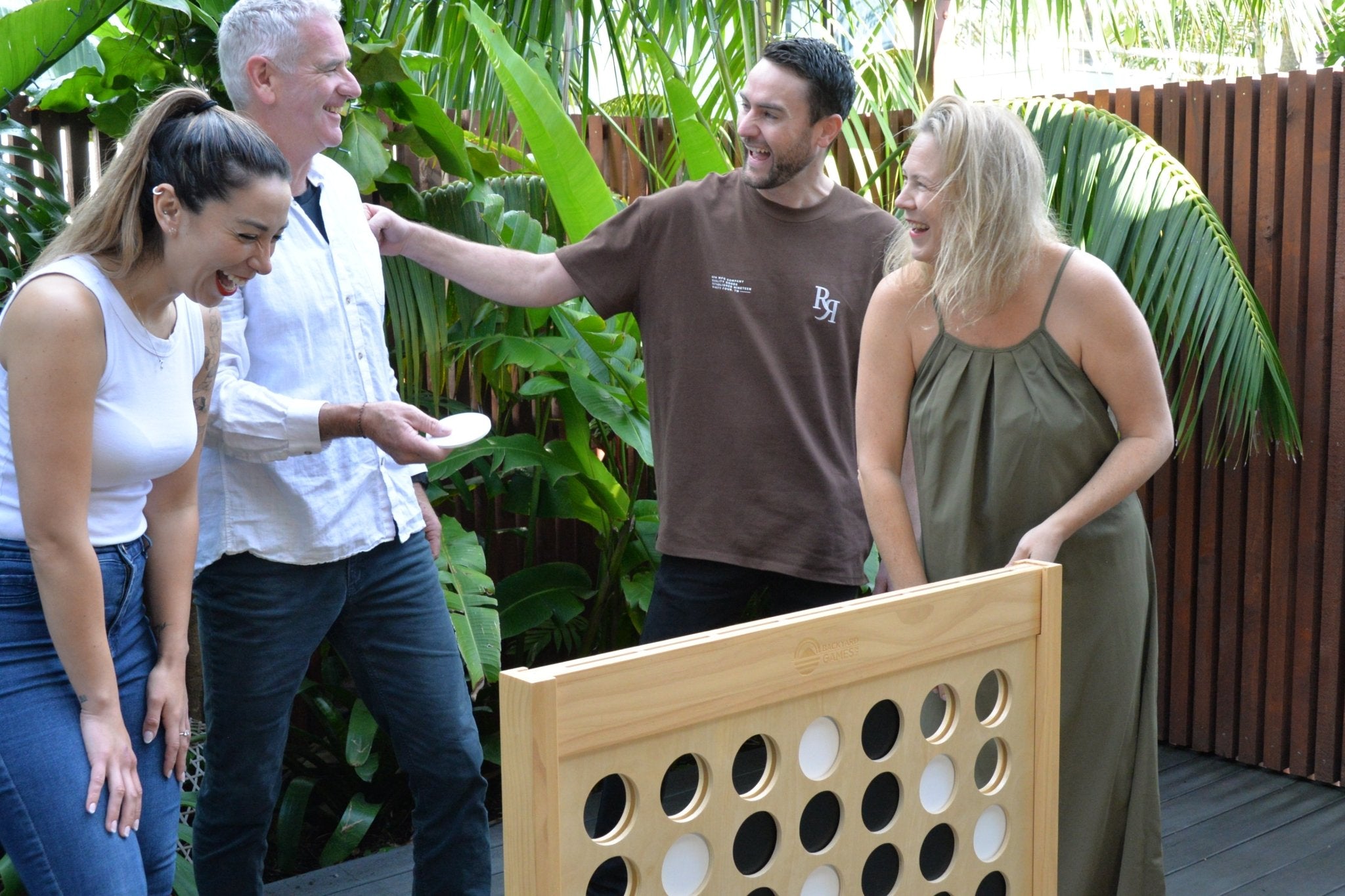 Group of people playing Backyard Games NZ Giant Connect Four outdoors