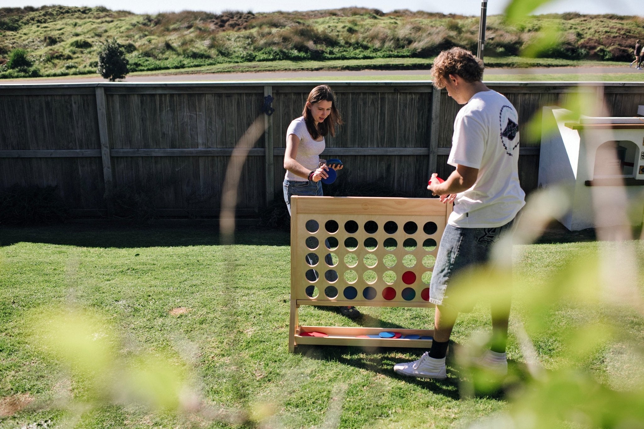 People playing premium outdoor games in a New Zealand backyard.