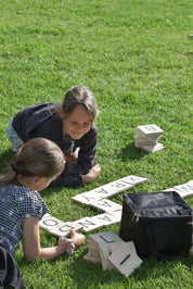 Two Girls Playing Backyard Games Giant Letter Tiles on the lawn