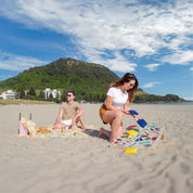 couple of the beach playing Backyard Games NZ Cornhole 