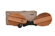 Wooden paddleboard game set with two wooden paddles, a black ball, and a beige carrying case on a white background.