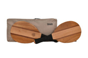 Two wooden paddleboard sports equipment pieces with black handles laid in front of a beige carrying case on a white background. The case has the text 'BACKYARD GAMES' printed on it.